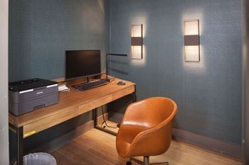 Home office workspace with wooden desk and modern lighting